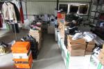 Na wieszakach i na kartonach leżą podrabiane ubrania i buty